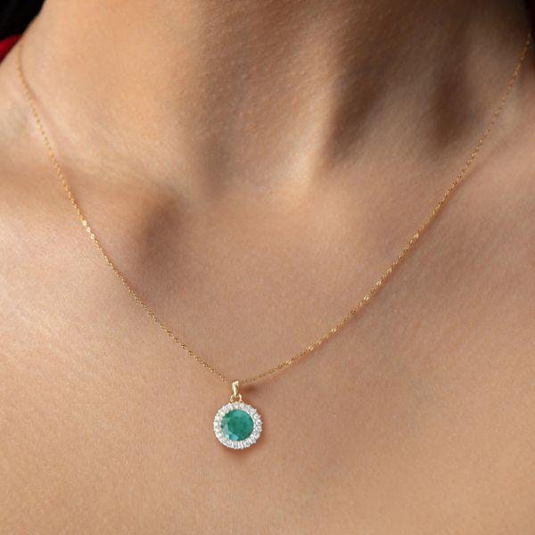 Emerald and diamond halo necklace